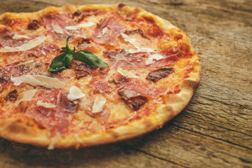 pizza with prosciutto ham, parmesan cheese and dried tomatoes