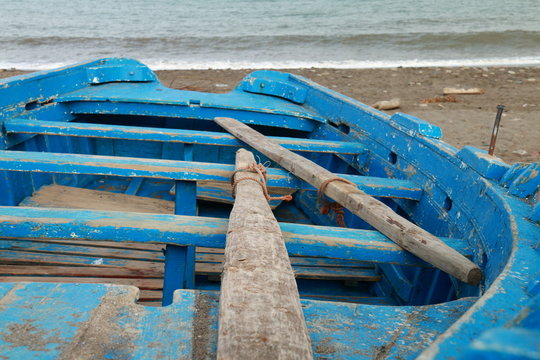 Old boat stranded on the sand of the beach