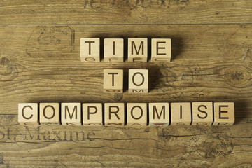 time to compromise text on cubes on wooden background