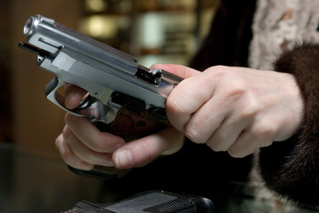 Close up of woman holding a gun