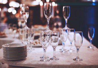 Wineglasses with plates on table service at banquet