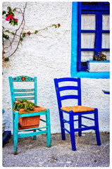 Typical cute wooden chairs in street taverna in Greece. artistic picture
