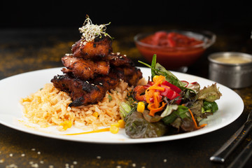 Rice and chicken grilled with spices and salad