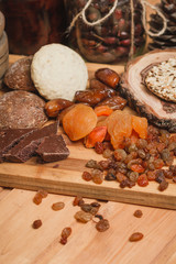 chocolate, dried apricots, and homemade cookies on a wooden board