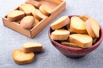 View close-up on slices of rusk in the old brown wooden crockery