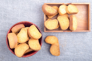 Top view of the pieces of dried bread in an old brown wooden cro