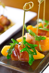 set of finger food, catering appetizers - prosciutto, melon, rucola