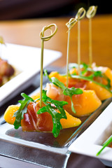 set of finger food, catering appetizers - prosciutto, melon, rucola