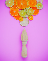Mixed fresh citrus fruits and wooden juicer for summer citrus ju
