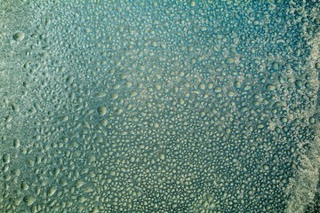 Window frozen at low temperature (in the cold). Formed ice and frost.
