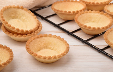 Group of fresh baked empty tart shells