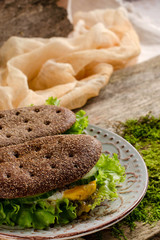 Healthy food - sandwiches of dark bread and poached eggs.