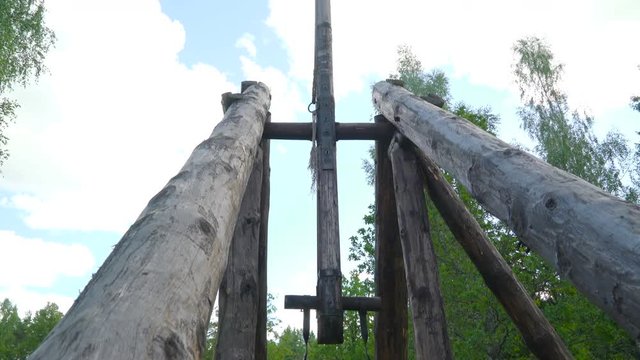 The big old wooden catapult found outside the lawn with the big stones on a bag to be thrown out