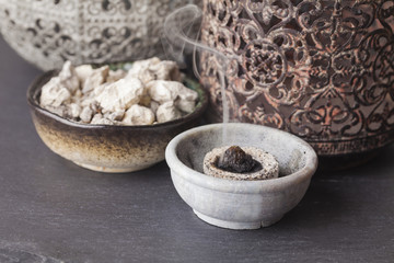 Copaifera officinalis resin burning on a hot coal. Copaifera (copaiba - bearer) is an aromatic resin, used for religious rites, incense and perfumes in Latin America