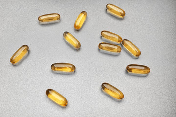 Fish oil capsules on grey background
