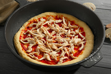 Unbaked pizza in pan, closeup