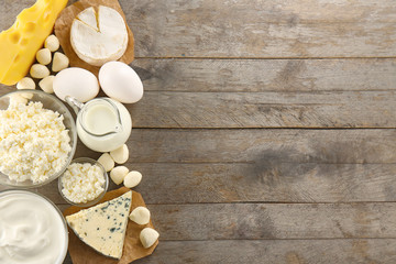 Different types of dairy products on wooden background