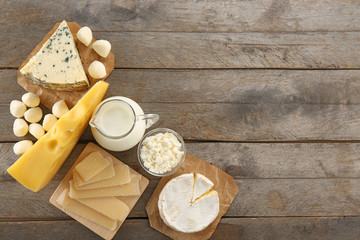 Different types of dairy products on wooden background