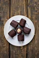 Frozen banana covered with chocolate, top view