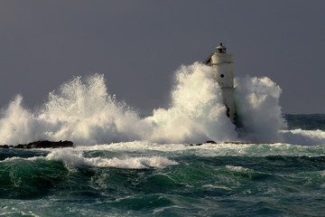 Mangiabarche Sardinia, Italy. Storm. Waves smash against lighthouse or beacon © Solasulmare