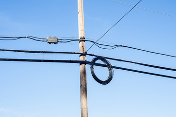 Electric power lines supported on wooden pole