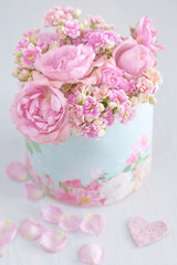 Lovely bunch of flowers .Beautiful fresh roses flowers in a box decorated with a heart .