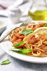 Spaghetti with shrimps in a tomato sauce.
