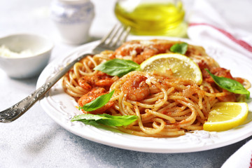 Spaghetti with shrimps in a tomato sauce.