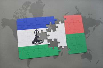 puzzle with the national flag of lesotho and madagascar on a world map