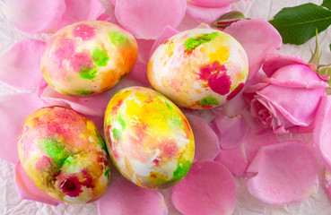 Painted Easter egg on pink rose petals