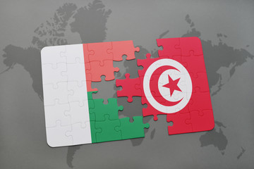 puzzle with the national flag of madagascar and tunisia on a world map