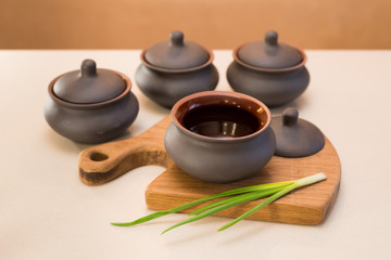 clay pots on the table, onions 

