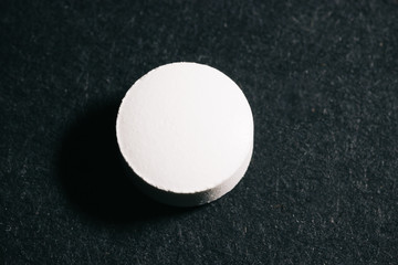 Pill isolated alone in under a spotlight
