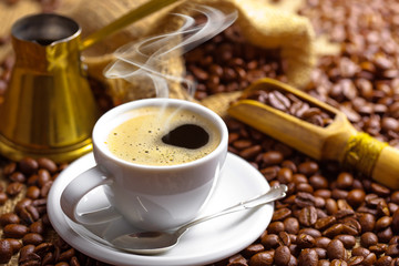 Black coffee in a cup on old background