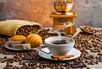 Black coffee in a cup on old background