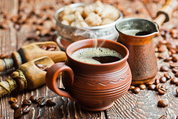 Black coffee in a cup on old background