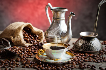 Black coffee in a cup on old background