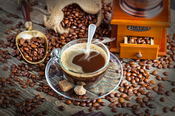 Black coffee in a cup on old background