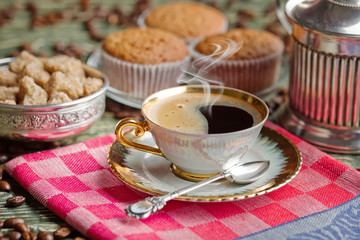 Black coffee in a cup on old background