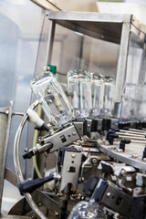 The bottles on the conveyor belt at the plant for bottling of al