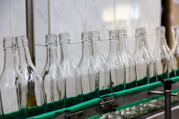 The bottles on the conveyor belt at the plant for bottling of al