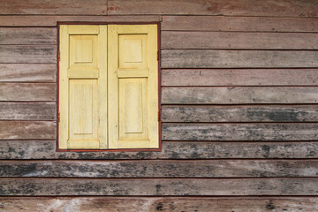 Naklejka na ściany i meble The external wood green window and wall of a vintage wood house.