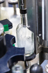 Russian vodka is poured on the conveyor belt at the plant.