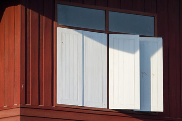 The external wood white window and wall of a vintage wood house.