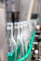 The bottles on the conveyor belt at the plant for bottling of al