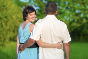 Obraz premium Family Values Concepts and Ideas. Two Caucasian Mature Adults Embracing Outdoors in Park