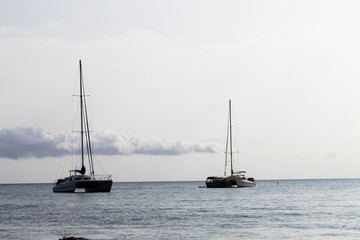 Obraz premium Two Catamaran Sailboats At Anchor Kona Hawaii