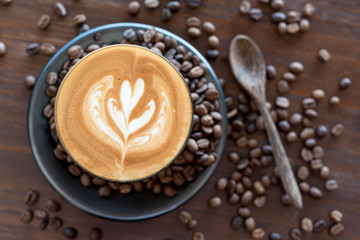 Top view of fresh coffe, latte art with coffee bean on wooden ta