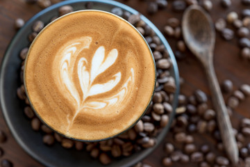 Top view of fresh coffe, latte art with coffee bean on wooden ta