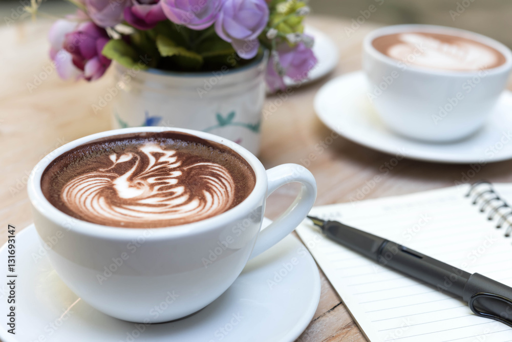 Wall mural two cups of latte art on wooden table